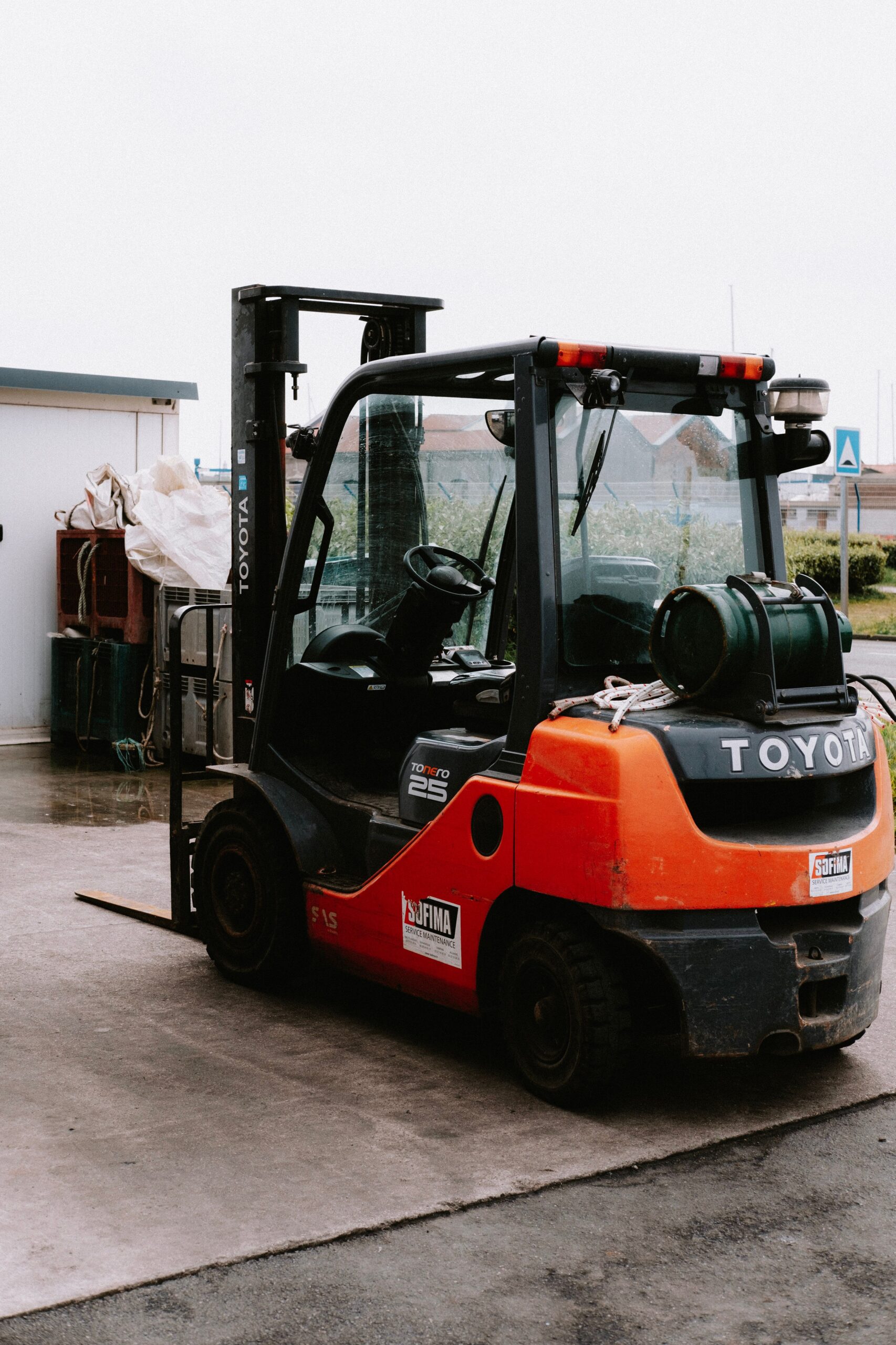Close-up of a parked Toyota forklift at an industrial site, showcasing utility and machinery.