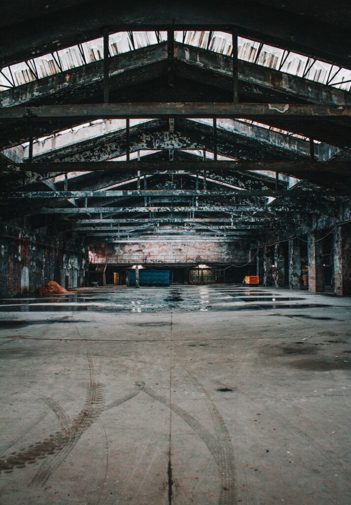 Moody view of an empty abandoned warehouse with metal roof in St. Petersburg, Russia.