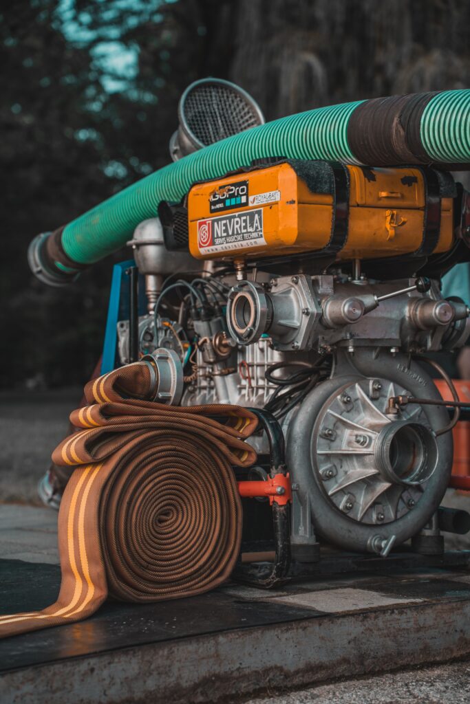 Detailed view of industrial pump with coiled hose, ideal for water and utility projects.