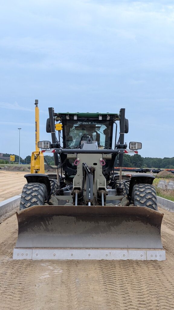 Front view of a heavy road grader on a construction site in Werlte.
